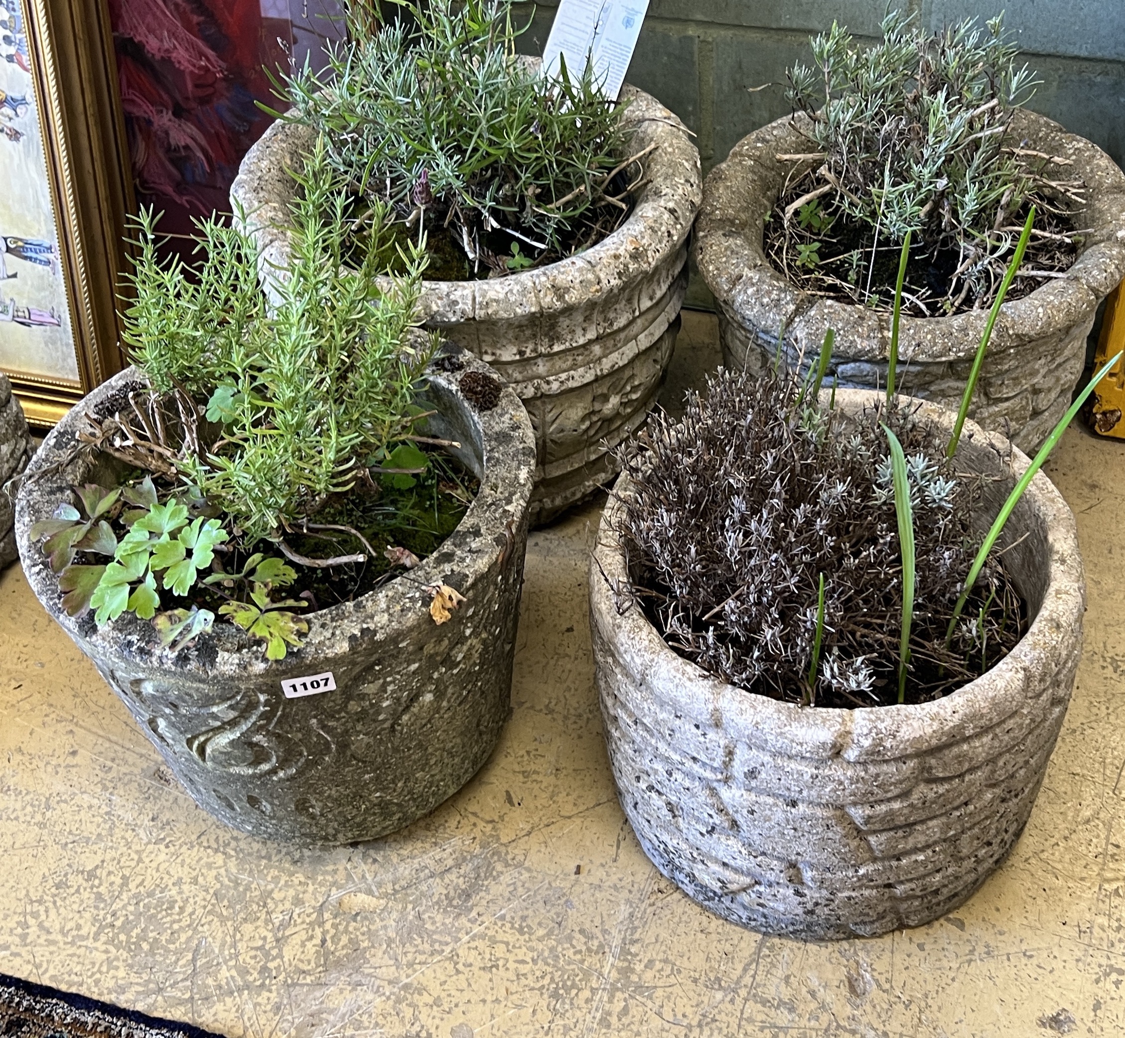 Four circular reconstituted stone garden planters, largest diameter 38cm, height 30cm